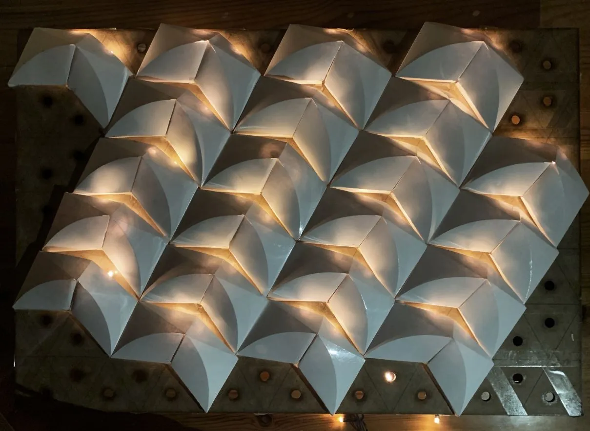 curved foldings tessellation: a regular grid of curved folds, lit from behind