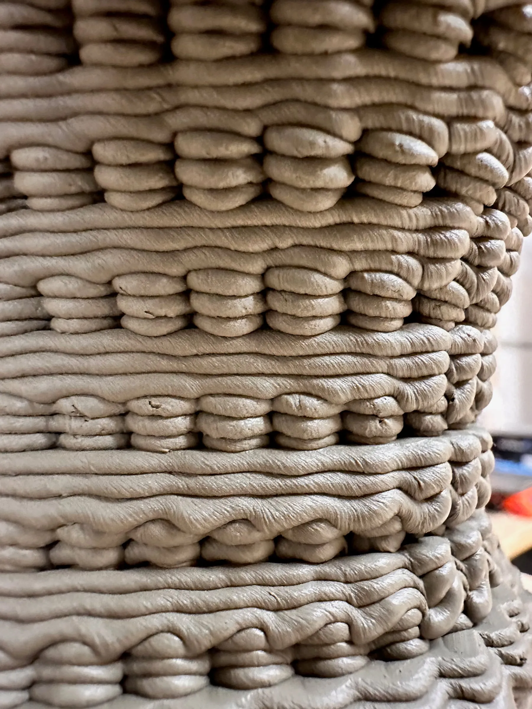 a printed clay piece, its surface knotted bead by bead