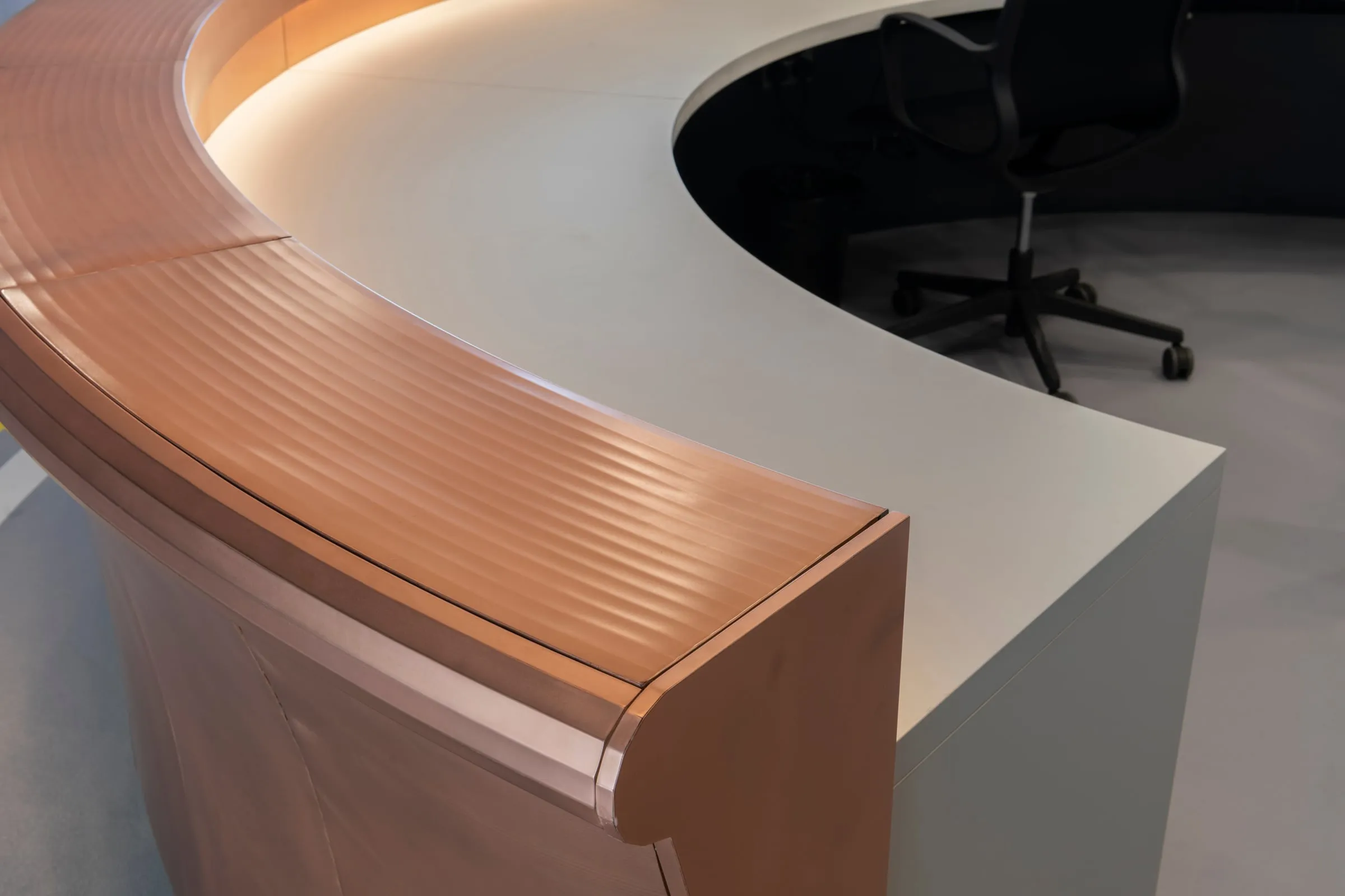 farsons old brewhouse desk, the copper rail from above, its fine ridges catching the light