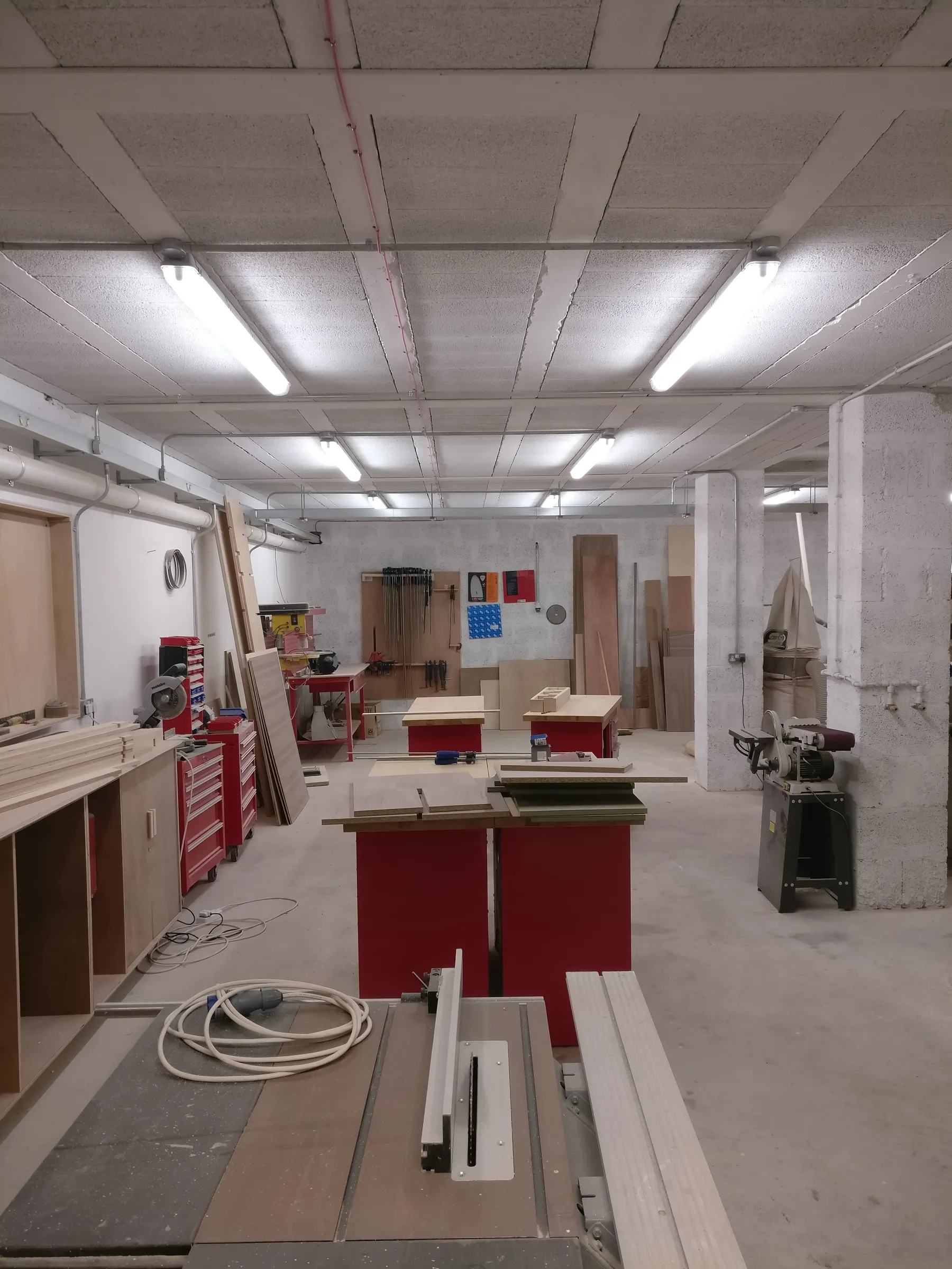 the timber shop at warehouse 7: table saw, benches and the clamp rack